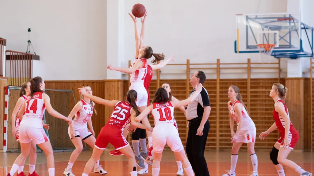 a women jump to pick basketball