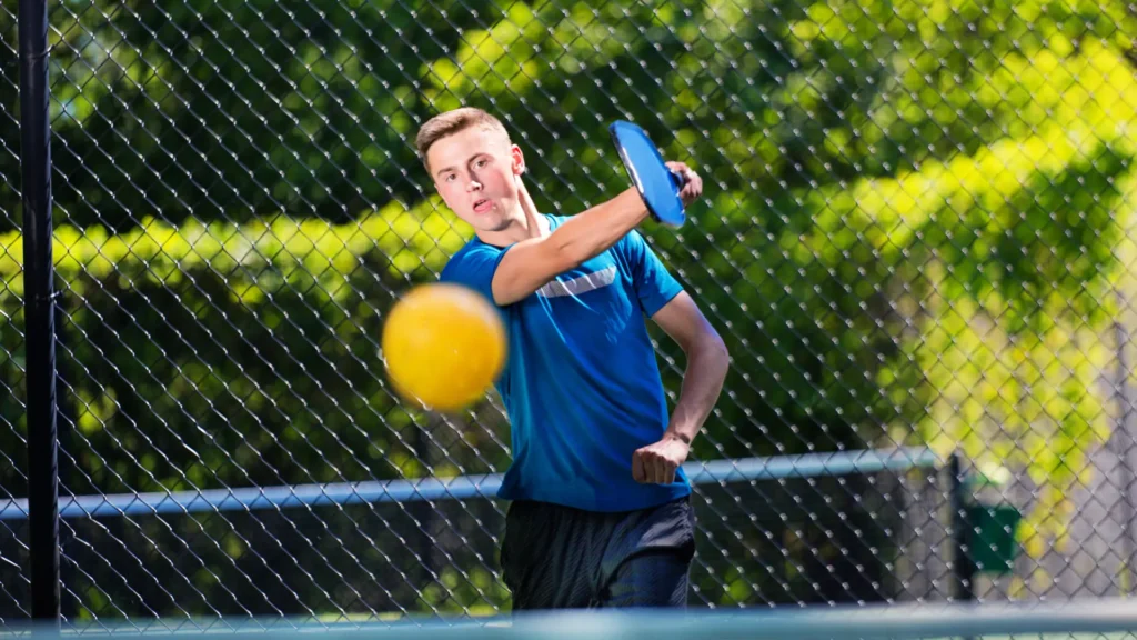 a boy playing pickleball